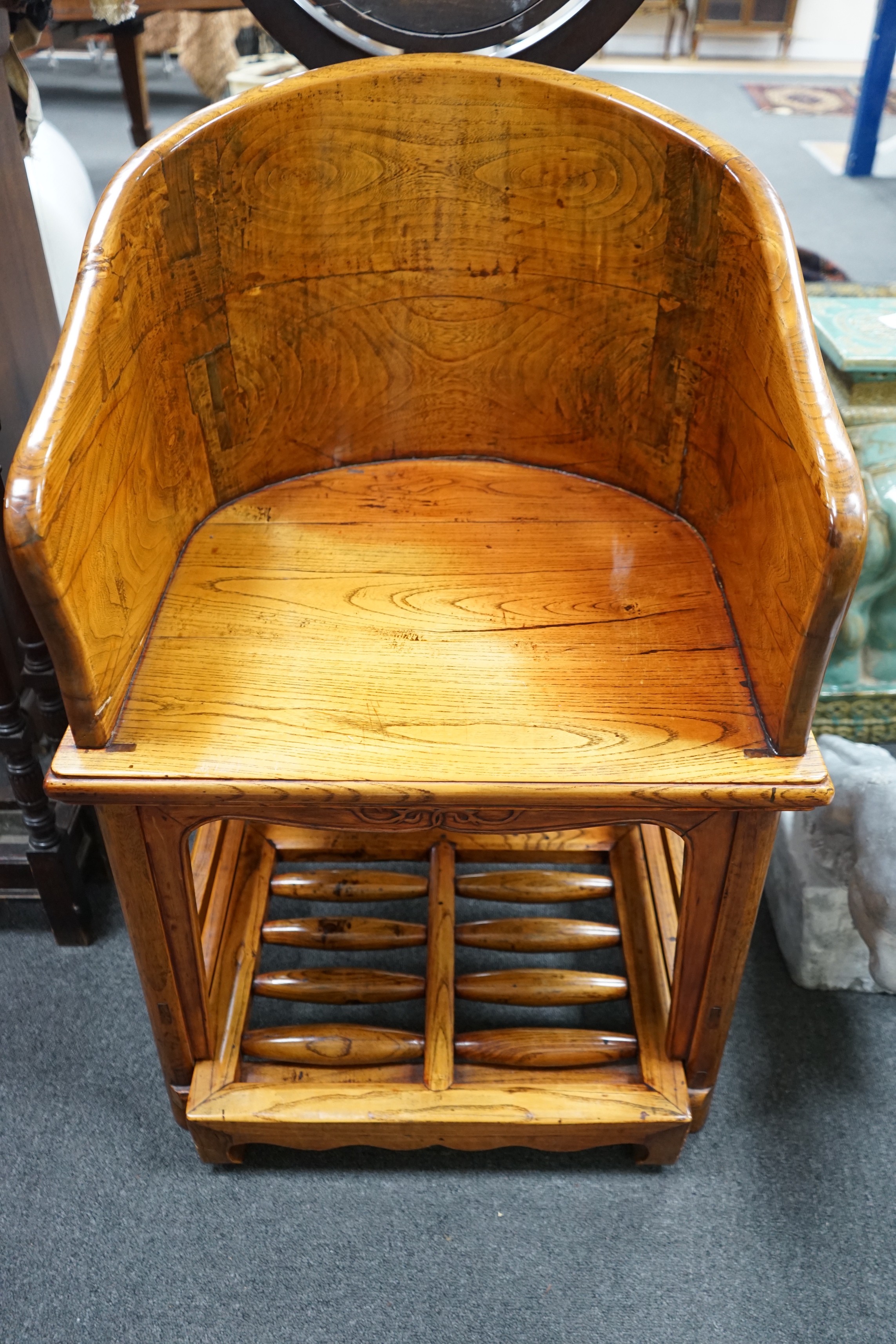 A pair of Chinese elm armchairs with roller footrests, width 57cm, depth 53cm, height 89cm